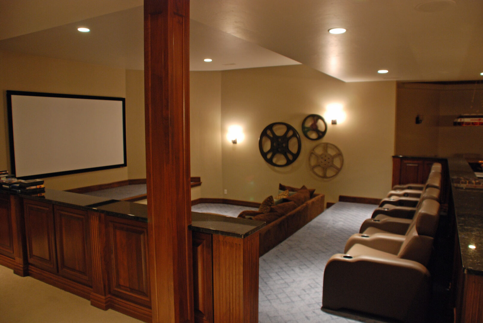 Home theater with reclining seats and a large screen